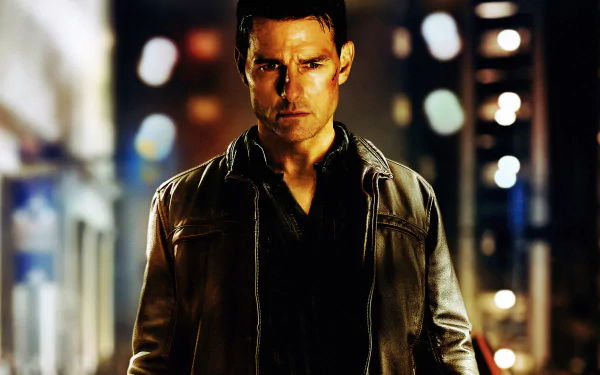 HD desktop wallpaper of Tom Cruise as Jack Reacher, featuring a moody, urban night scene with dramatic lighting and a focused expression.