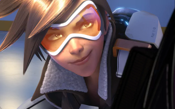 HD desktop wallpaper featuring Tracer from the video game Overwatch, showcasing her signature confident smile and goggles.
