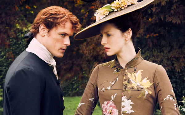 A captivating HD wallpaper featuring Claire Fraser (Caitriona Balfe) and Jamie Fraser (Sam Heughan) from the TV show Outlander, showcasing their intense connection and period attire.