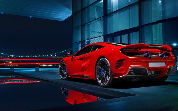 HD PC wallpaper showcasing a red McLaren 675LT supercar parked near a modern glass building with city lights and reflections at night.