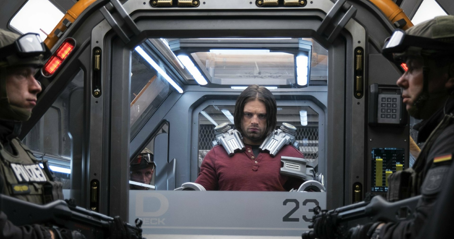 A scene from Captain America: Civil War, featuring a tense moment with a character in a high-tech containment chamber, surrounded by guards. A striking HD desktop wallpaper.