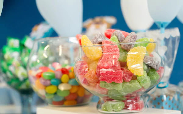 Colorful jelly beans and assorted sweets displayed in glass bowls, captured in vibrant 4K Ultra HD for a vivid PC desktop wallpaper background.