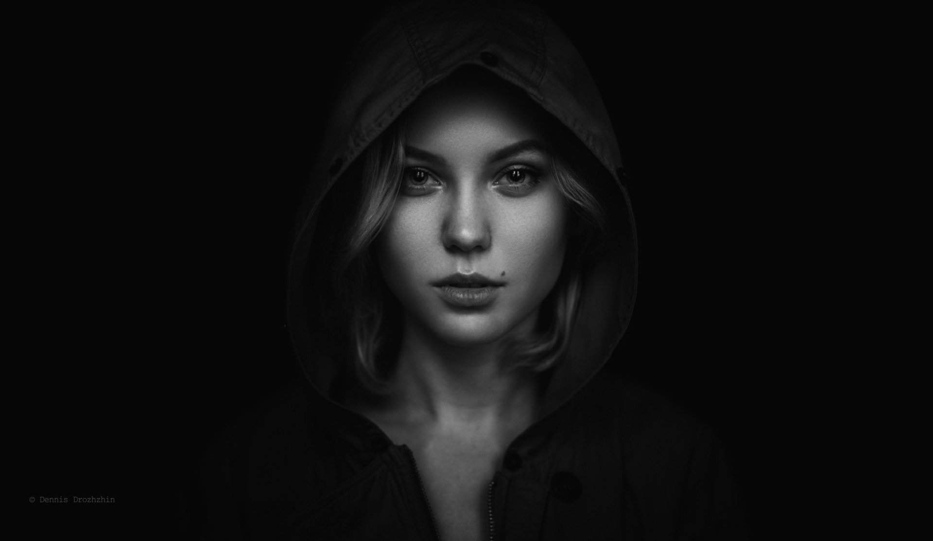 Monochrome HD portrait of a woman with a hood against a dark background, designed as a striking PC desktop wallpaper.