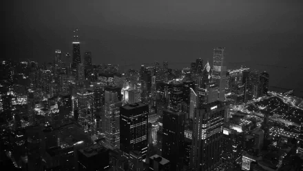 A stunning HD wallpaper featuring a panoramic black and white view of Chicago's skyline at night, showcasing the intricate details of the city's architecture and lights.
