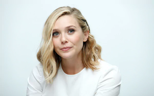 HD desktop wallpaper featuring a close-up portrait of celebrity Elizabeth Olsen with natural makeup and wavy blonde hair against a light background.