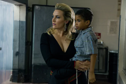 Kate Winslet, portrayed in a scene from the movie *Triple 9*, holds a young boy as they navigate a tense environment. This image serves as a striking 4K Ultra HD wallpaper.