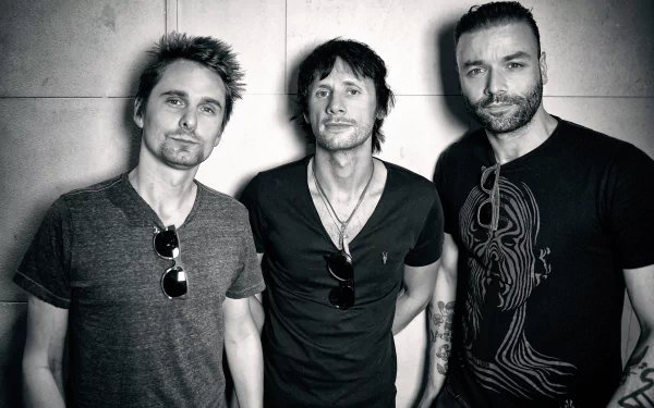 Black and white 4K Ultra HD wallpaper of Muse band members posing, highlighting the rock music trio with a moody, artistic vibe for PC backgrounds.