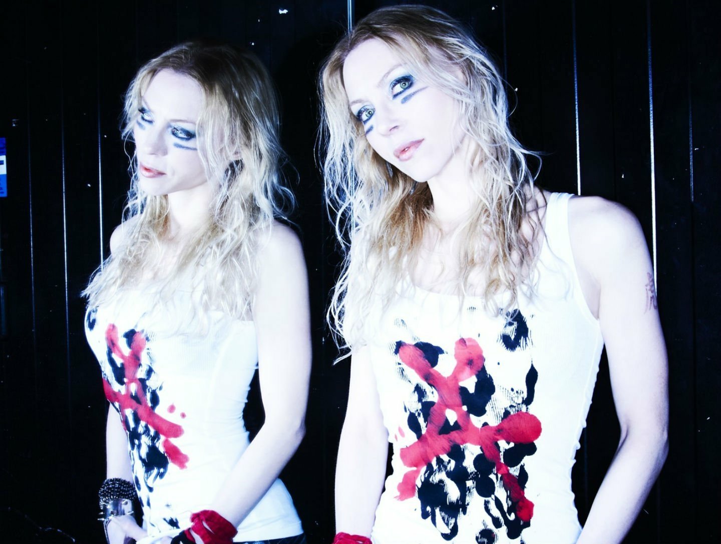HD PC desktop wallpaper featuring a high-contrast image of a woman with heavy makeup, wearing a white dress with red and black designs, representing music and Arch Enemy.