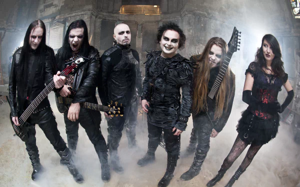 4K Ultra HD PC desktop wallpaper: gothic metal band in theatrical corpse-paint and leather, posing in a smoky, cathedral-like setting — music-themed dark aesthetic