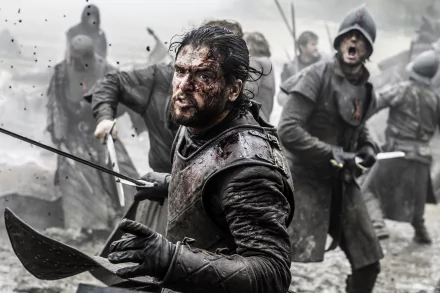 Jon Snow, portrayed by Kit Harington, fiercely battles in a dramatic scene from Game of Thrones, showcasing intense action and a gritty atmosphere in this HD wallpaper.