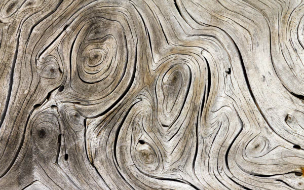 Abstract wood texture with swirling grain patterns in 4K Ultra HD, designed as a detailed and natural PC desktop wallpaper background.
