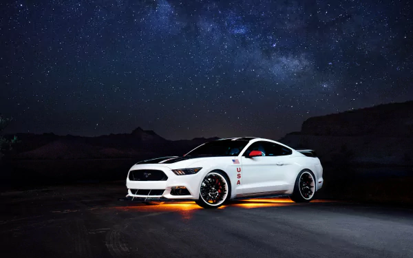 A white Ford Mustang with glowing orange underglow lights parked under a star-filled night sky, captured in 4K Ultra HD for a PC desktop background.