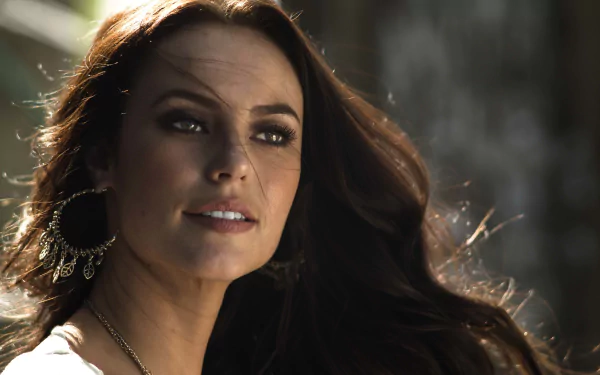 Close-up of Brazilian model Paola Oliveira with brunette hair, wearing large earrings, captured in 4K Ultra HD for a PC desktop wallpaper and background.