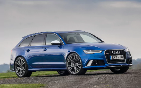 HD PC desktop wallpaper featuring a vibrant blue Audi RS6 parked on a gravel surface under a cloudy sky, showcasing the sleek design of this Audi vehicle.