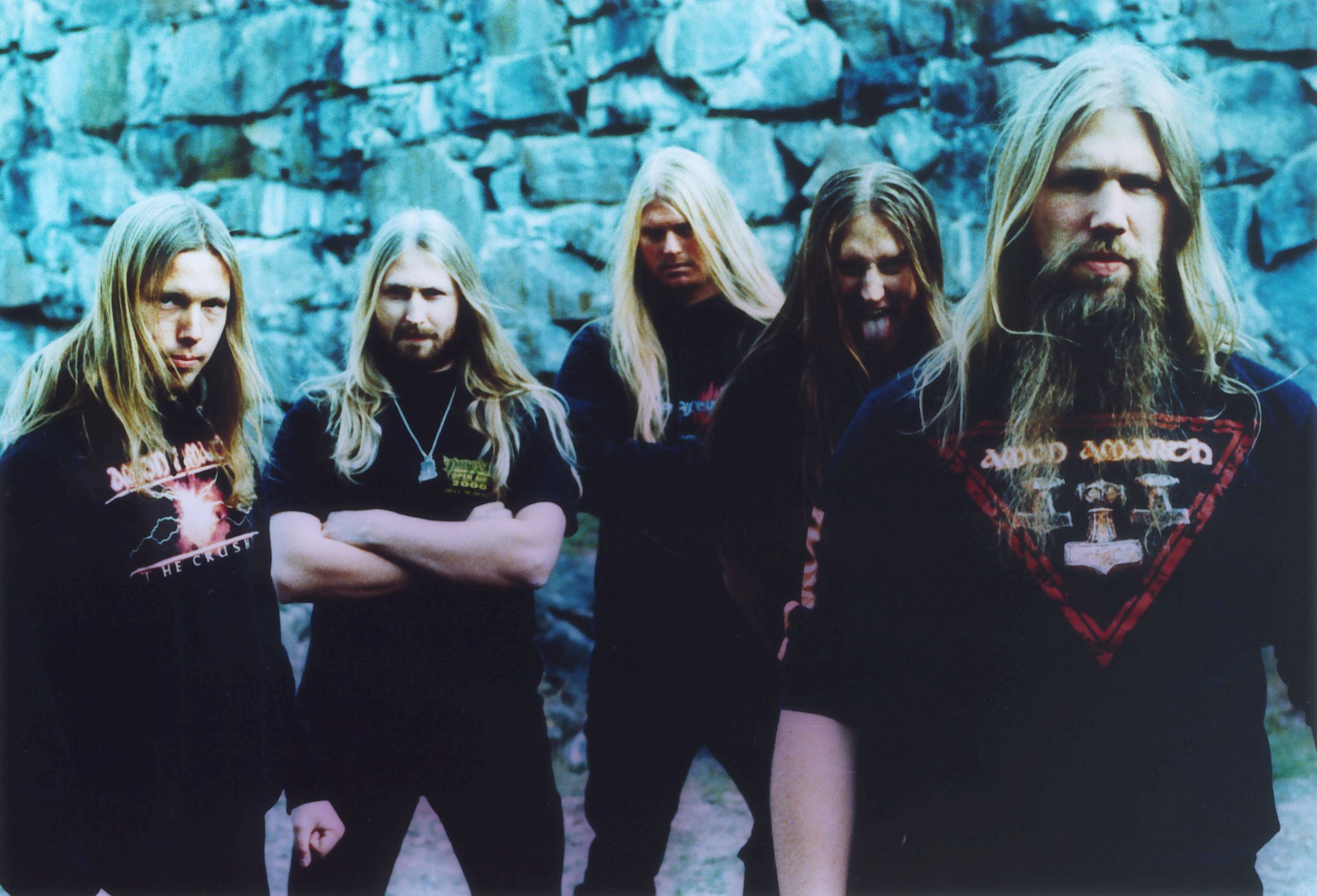 HD wallpaper featuring the Swedish melodic death metal band Amon Amarth, showcasing the members in a dramatic pose against a stone backdrop.