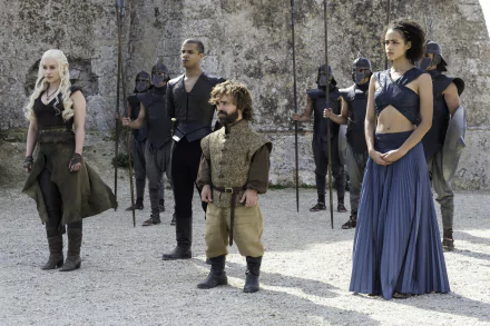 A scene from Game of Thrones featuring Daenerys Targaryen, Tyrion Lannister, Grey Worm, and Missandei, surrounded by guards, set against a stone backdrop.