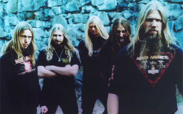 HD wallpaper featuring the Swedish melodic death metal band Amon Amarth, showcasing the members in a dramatic pose against a stone backdrop.