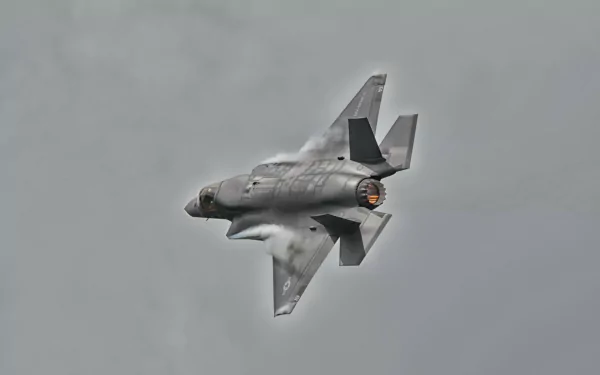 Lockheed Martin F-35 Lightning II jet fighter warplane banking through a cloudy sky — 4K Ultra HD PC desktop wallpaper background.