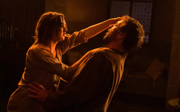 4K Ultra HD wallpaper of Maisie Williams as Arya Stark from Game of Thrones in a tense, dimly lit confrontation scene.