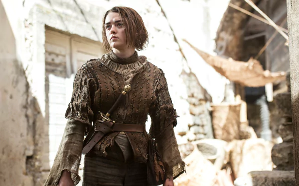 Arya Stark from Game of Thrones in rugged leather gear, standing in a sunlit ruined courtyard — 4K Ultra HD PC desktop wallpaper.