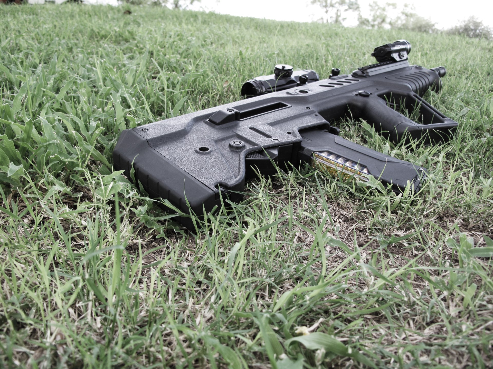 IWI Tavor Black - up close on a grass field by t4vor