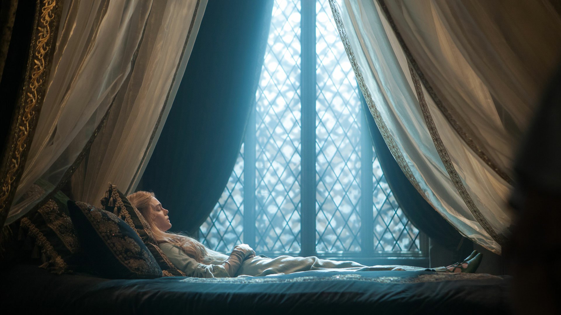 HD PC desktop wallpaper featuring a serene scene from the movie Maleficent, with a character resting by a window framed by flowing curtains.