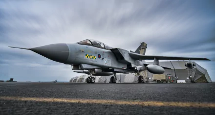 HD desktop wallpaper featuring a Panavia Tornado jet fighter warplane parked on the runway under a cloudy sky, showcasing military aircraft power and design.