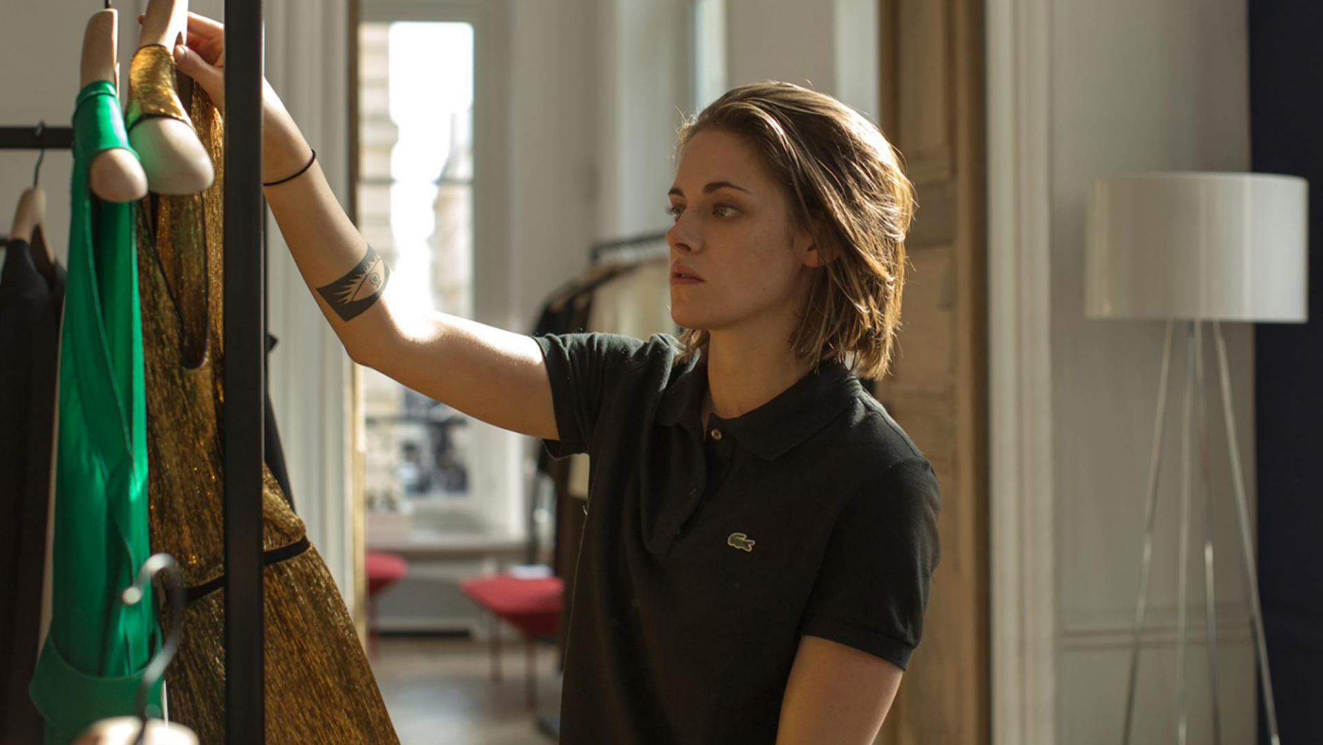 HD desktop wallpaper featuring Kristen Stewart in a scene from the movie Personal Shopper, showcasing her focused expression and casual black outfit.