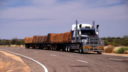 A Western Star road train navigates a winding outback road in Australia, showcasing the rugged landscape and expansive skies in a striking 4K Ultra HD view.