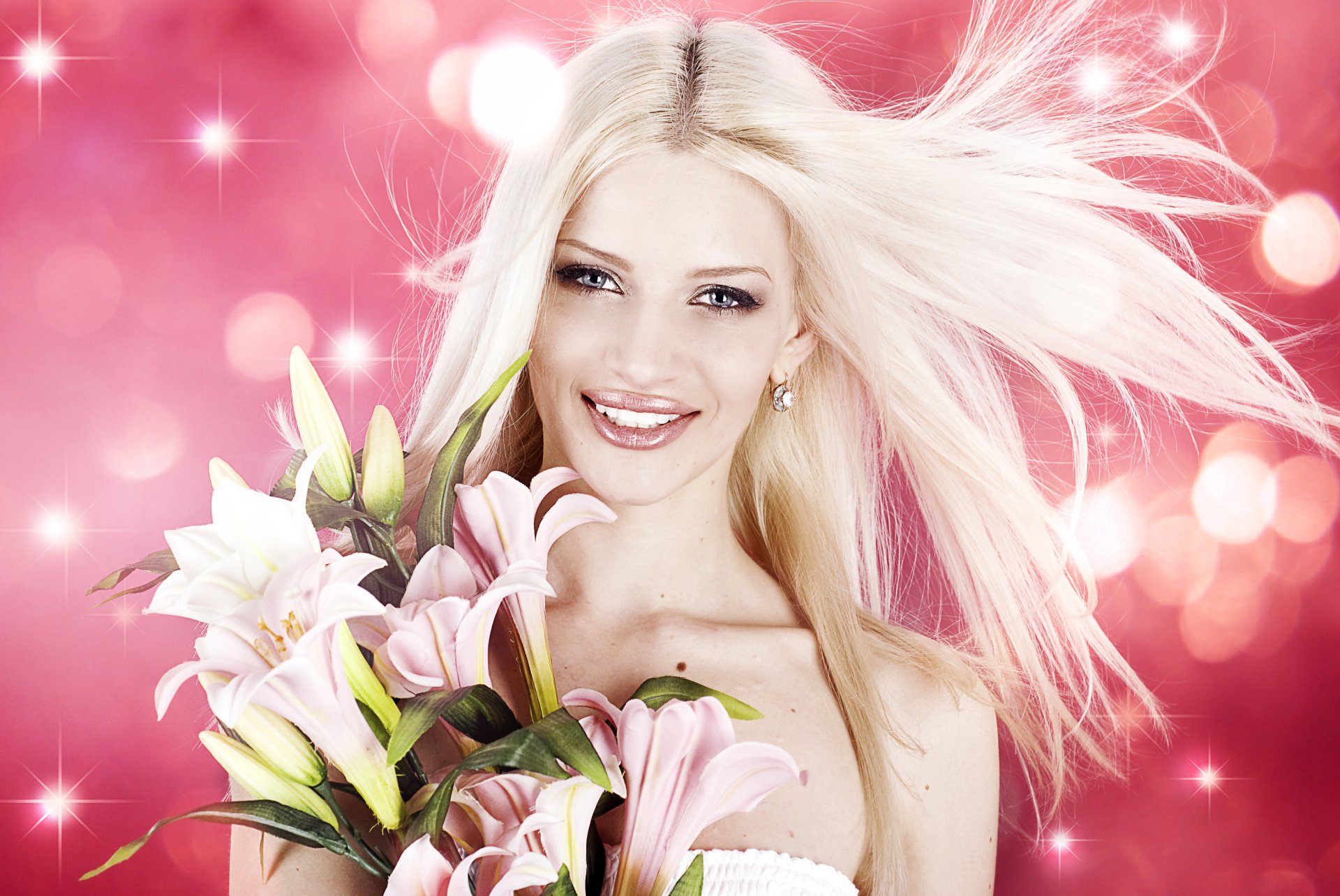 Blonde woman with blue eyes smiles holding pink and white lilies against a sparkling pink bokeh background in this 4K Ultra HD desktop wallpaper.