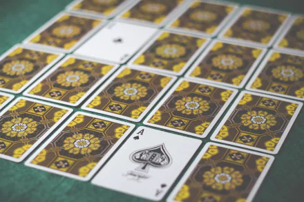 A vibrant collection of playing cards featuring intricate designs, arranged on a green surface, showcased as a 4K Ultra HD PC desktop wallpaper and background.
