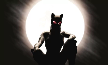 HD PC desktop wallpaper featuring a comic-style Catwoman silhouetted against a bright full moon with glowing eyes in a dark, moody atmosphere.