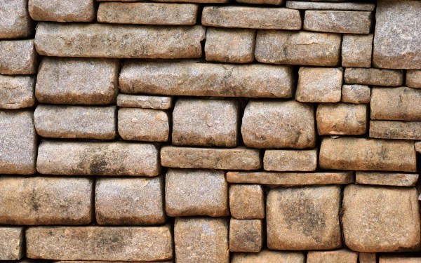 5K Ultra HD PC desktop wallpaper: close-up of a man-made stone wall showing rectangular textured stones arranged in a tight masonry pattern.