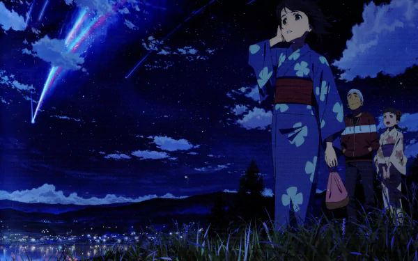 Mitsuha Miyamizu stands gazing at a starry sky, adorned in a blue kimono, as vibrant comets streak overhead. A stunning HD wallpaper from the anime *Your Name.*