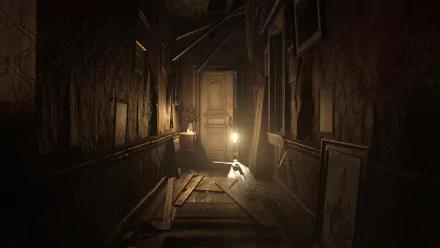 HD PC desktop wallpaper/background from the video game Resident Evil 7: Biohazard — a decaying, dim hallway with broken floorboards and a lantern-lit door at the end.