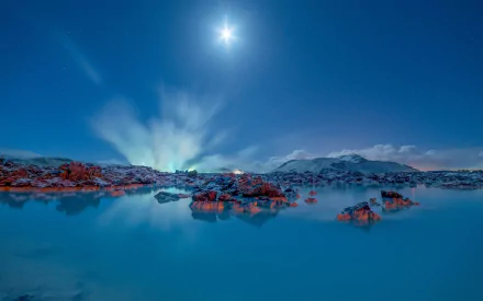 A stunning winter scene of a snow-covered lagoon in Iceland, reflecting the moonlight and surrounded by icy rocks, showcasing the serene beauty of nature in HD clarity.