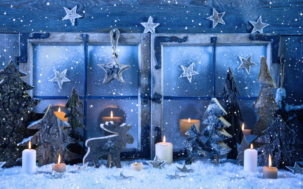 A cozy holiday scene featuring snowflakes, candles, and festive decorations, including a reindeer and star-shaped ornaments, viewed through a window adorned with a wintery backdrop.