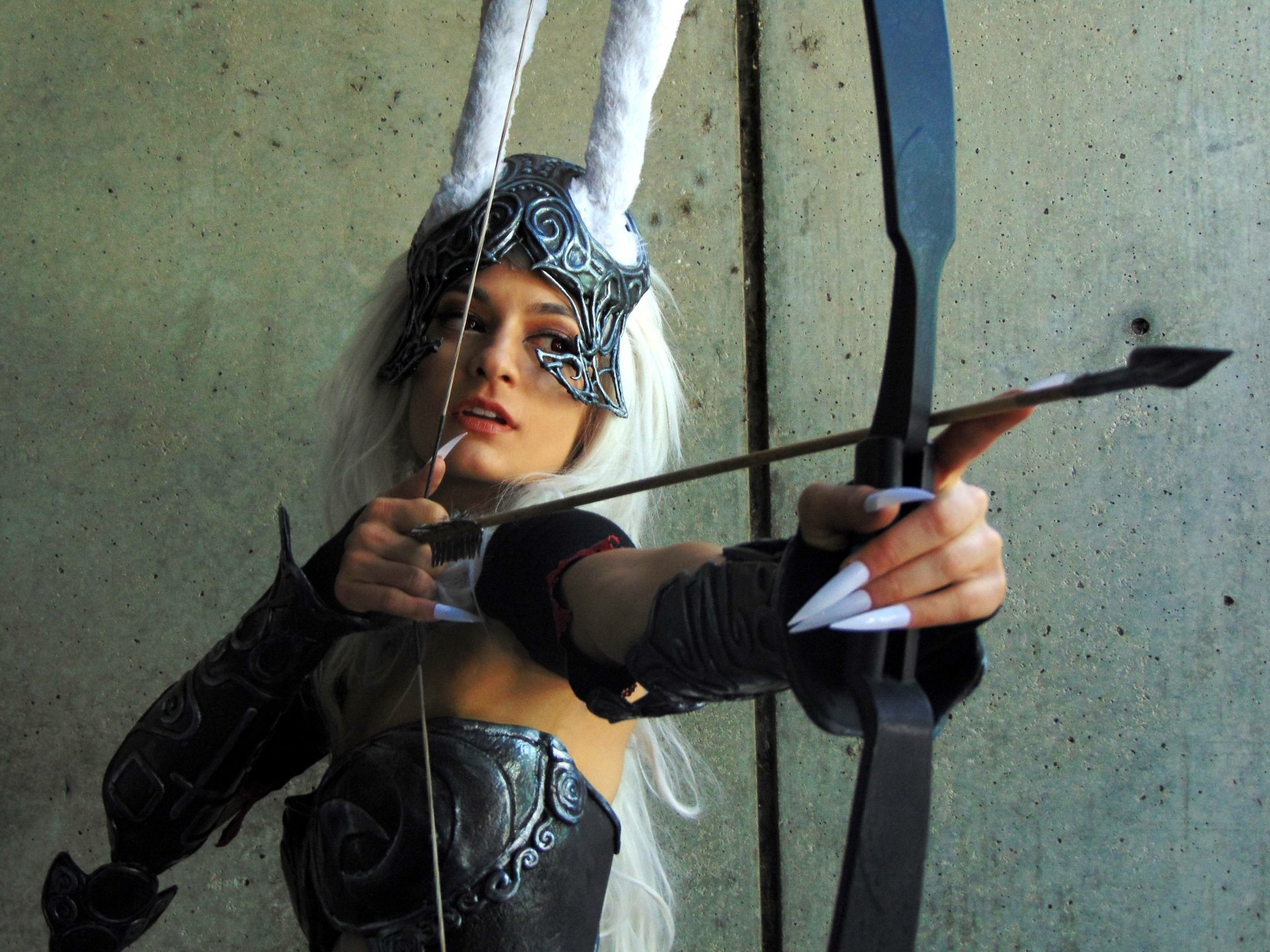 A woman in detailed cosplay armor aiming a bow, captured in 4K Ultra HD resolution, designed as a PC desktop wallpaper and background.