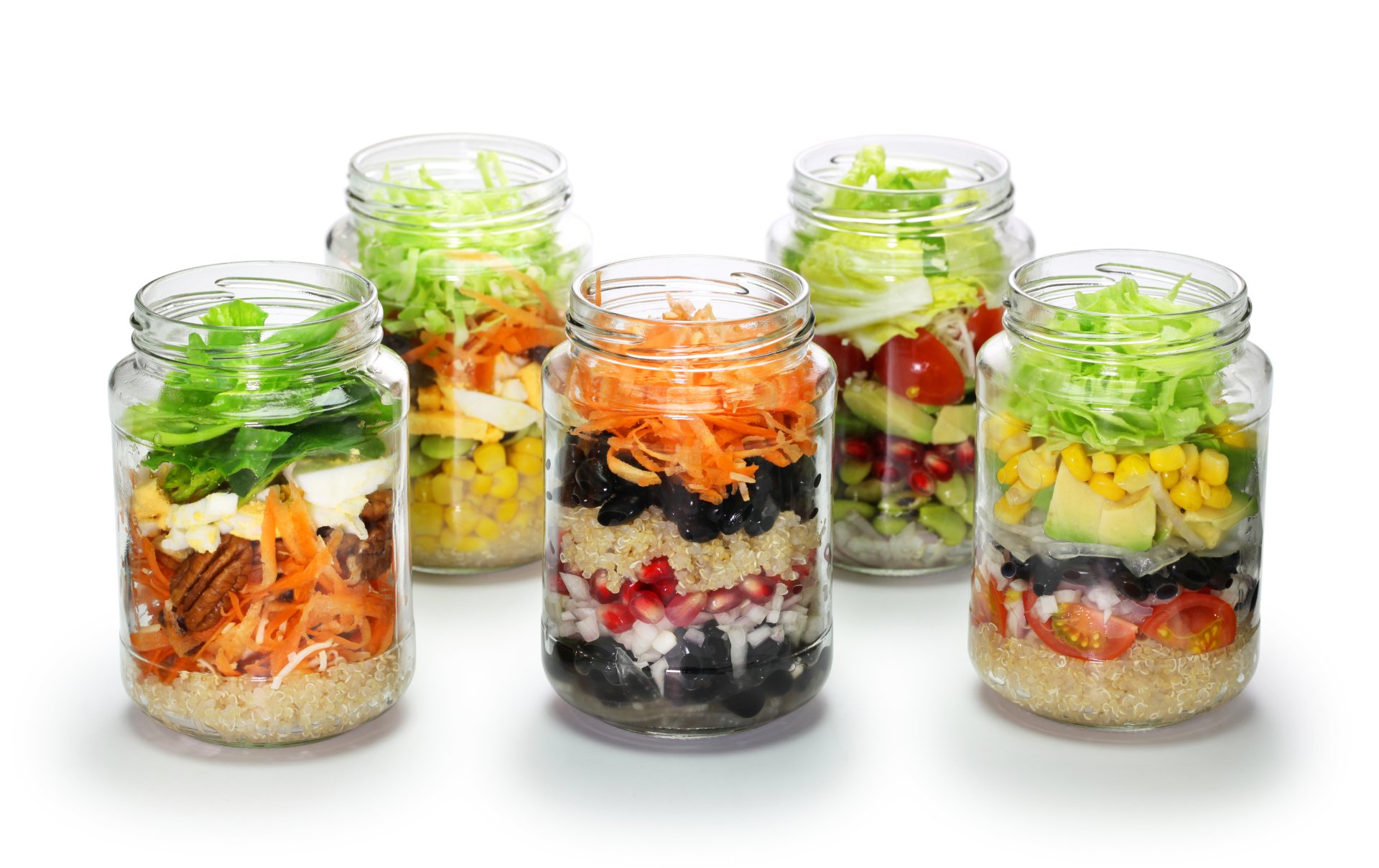 A vibrant 4K Ultra HD desktop wallpaper featuring jars filled with layered salad ingredients like beans, corn, lettuce, pomegranate, cucumber, nuts, carrot, and tomato.
