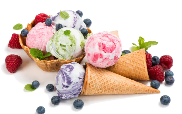 A vibrant 4K Ultra HD image of colorful ice cream scoops in waffle cones and a waffle bowl, garnished with fresh blueberries, raspberries, and mint leaves on a white background.