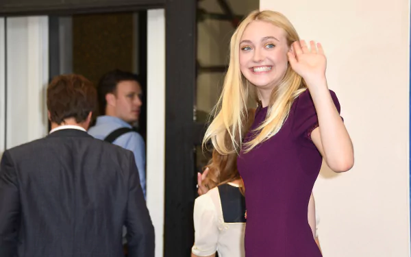 Celebrity Dakota Fanning waves and smiles, featured in a sharp 4K Ultra HD PC desktop wallpaper and background.