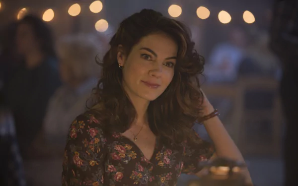 HD PC desktop wallpaper featuring a female character from the TV show True Detective, with warm bokeh lights softly glowing in the background.