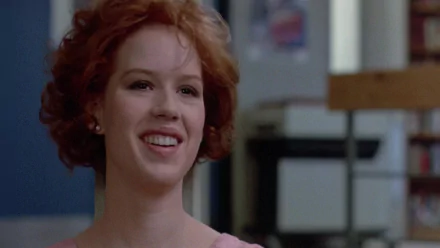 HD PC desktop wallpaper featuring Molly Ringwald as Claire Standish from the movie The Breakfast Club, capturing her iconic smile and red hair.