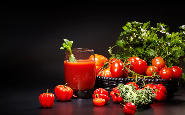 4K Ultra HD desktop wallpaper featuring fresh tomatoes, a glass of tomato juice garnished with mint, and vibrant green herbs on a dark background.