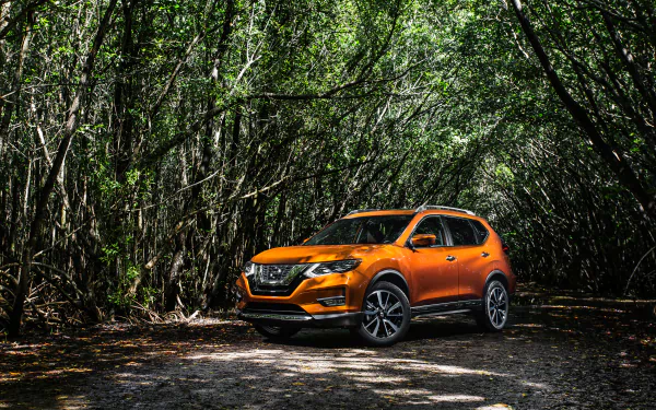 Orange Nissan Rogue SUV parked on a forest trail, captured in 4K Ultra HD as a vivid PC desktop wallpaper and background.