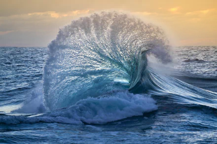 A stunning wave crashes in the ocean, capturing the beauty of nature. This HD image serves as a captivating desktop wallpaper, showcasing the dynamic power of water.