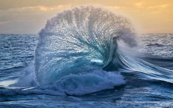 A stunning wave crashes in the ocean, capturing the beauty of nature. This HD image serves as a captivating desktop wallpaper, showcasing the dynamic power of water.