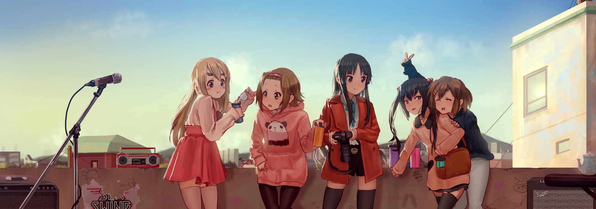 HD anime desktop wallpaper featuring the K-ON! characters gathered together outdoors with a clear sky background, showcasing their distinct outfits and personalities.