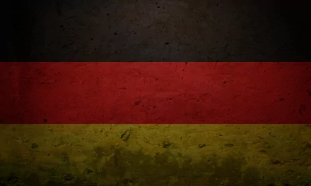 A textured HD wallpaper featuring the flag of Germany, showcasing the iconic black, red, and yellow stripes against a rugged background.