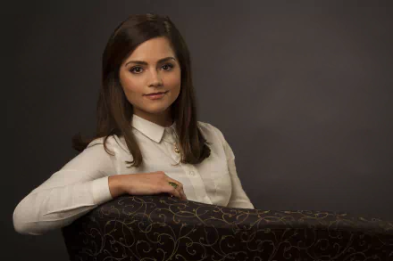 HD desktop wallpaper featuring English actress Jenna Coleman with brunette hair and brown eyes against a dark background.